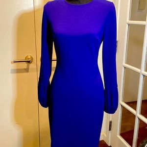 Polyester/spandex blend. Back zipper. Small slit. Excellent condition.